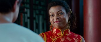 Movie still from “The Karate Kid” (2010), directed by Harald Zwart – A person wearing a red and yellow dress; Close Up shot, Over the shoulder angle