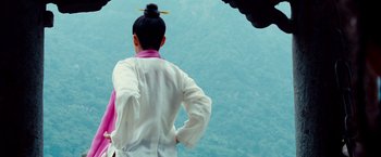 Movie still from “The Karate Kid” (2010), directed by Harald Zwart – A person standing in front of a body of water; Medium shot, Low angle