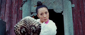 Movie still from “The Karate Kid” (2010), directed by Harald Zwart – A woman in a white shirt is looking at the camera; Close Up shot, Low angle