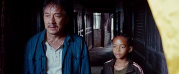 Movie still from “The Karate Kid” (2010), directed by Harald Zwart – A man standing next to a young girl in an alley way; Close Up shot, Over the shoulder angle