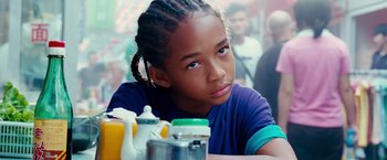 Movie still from “The Karate Kid” (2010), directed by Harald Zwart – A young girl sitting at a table in front of a tea pot; Close Up shot, Over the shoulder angle