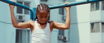 Movie still from “The Karate Kid” (2010), directed by Harald Zwart – A little girl holding onto a blue pole; Close Up shot, Low angle