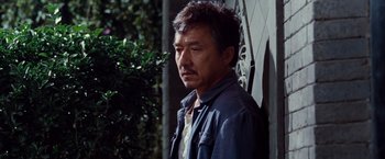 Movie still from “The Karate Kid” (2010), directed by Harald Zwart – A person standing near a tree; Close Up shot, Over the shoulder angle