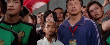 Movie still from “The Karate Kid” (2010), directed by Harald Zwart – A group of people standing in front of each other; Close Up shot, Low angle