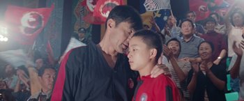 Movie still from “The Karate Kid” (2010), directed by Harald Zwart – A man and a young boy standing next to each other; Close Up shot, Low angle