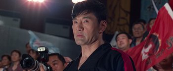 Movie still from “The Karate Kid” (2010), directed by Harald Zwart – A person wearing a black shirt; Close Up shot, Low angle