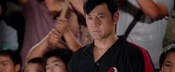 Movie still from “The Karate Kid” (2010), directed by Harald Zwart – A person wearing a black shirt; Close Up shot, Over the shoulder angle