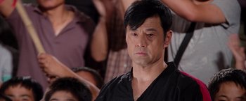 Movie still from “The Karate Kid” (2010), directed by Harald Zwart – A person wearing a black shirt; Close Up shot, Over the shoulder angle