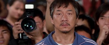 Movie still from “The Karate Kid” (2010), directed by Harald Zwart – A person taking a picture of another person; Close Up shot, Over the shoulder angle