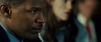 Movie still from “The Kingdom” (2007), directed by Peter Berg – A person looking at the camera; Close Up shot, Over the shoulder angle