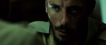 Movie still from “The Kingdom” (2007), directed by Peter Berg – A person with a beard; Close Up shot, Over the shoulder angle