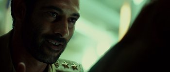 Movie still from “The Kingdom” (2007), directed by Peter Berg – A person wearing a military uniform; Close Up shot, Over the shoulder angle