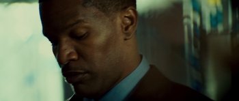 Movie still from “The Kingdom” (2007), directed by Peter Berg – A person wearing a suit and tie; Close Up shot, Over the shoulder angle