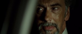 Movie still from “The Kingdom” (2007), directed by Peter Berg – A person with a beard; Extreme Close Up shot, Over the shoulder angle