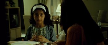 Movie still from “The Kingdom” (2007), directed by Peter Berg – A young girl sitting in front of a mirror; Medium shot, Over the shoulder angle