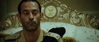 Movie still from “The Kingdom” (2007), directed by Peter Berg – A person wearing a military uniform; Close Up shot, Low angle