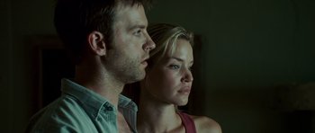Movie still from “The Kingdom” (2007), directed by Peter Berg – A man and a woman looking at something in the distance; Close Up shot, Low angle