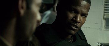 Movie still from “The Kingdom” (2007), directed by Peter Berg – A man's face in the dark; Close Up shot, Over the shoulder angle