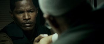 Movie still from “The Kingdom” (2007), directed by Peter Berg – A man looking at his reflection in a mirror; Close Up shot, Over the shoulder angle