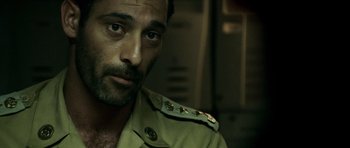 Movie still from “The Kingdom” (2007), directed by Peter Berg – A person wearing a uniform; Close Up shot, Over the shoulder angle