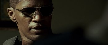 Movie still from “The Kingdom” (2007), directed by Peter Berg – A person wearing sunglasses; Close Up shot, Low angle