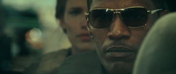 Movie still from “The Kingdom” (2007), directed by Peter Berg – A person wearing sunglasses; Extreme Close Up shot, Low angle
