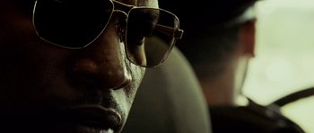 Movie still from “The Kingdom” (2007), directed by Peter Berg – A man's face wearing a pair of sunglasses; Extreme Close Up shot, Low angle