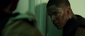 Movie still from “The Kingdom” (2007), directed by Peter Berg – A man's face in front of a mirror; Close Up shot, Low angle