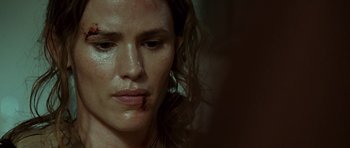 Movie still from “The Kingdom” (2007), directed by Peter Berg – A woman's face with brown makeup; Close Up shot, Over the shoulder angle