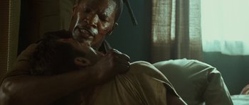 Movie still from “The Kingdom” (2007), directed by Peter Berg – A man with blood on his face and arm; Close Up shot, Over the shoulder angle