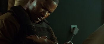 Movie still from “The Kingdom” (2007), directed by Peter Berg – A man with blood all over his face and hands; Close Up shot, Over the shoulder angle