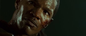 Movie still from “The Kingdom” (2007), directed by Peter Berg – A man's face covered in blood; Close Up shot, High angle