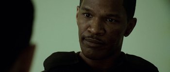 Movie still from “The Kingdom” (2007), directed by Peter Berg – A man's face in a black shirt; Close Up shot, High angle