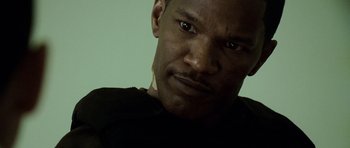 Movie still from “The Kingdom” (2007), directed by Peter Berg – A person with a black shirt; Close Up shot, Low angle