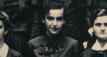 Movie still from “The Last Days” (1998), directed by James Moll – An old photograph of a woman in a dress; Close Up shot, High angle