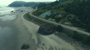 Movie still from “The Midnight Club” (2022), created by Mike Flanagan – An aerial view of a road on the side of a hill; Extreme Wide shot, High angle