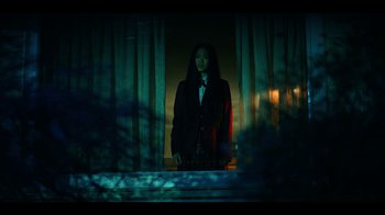 Movie still from “The Midnight Club” (2022), created by Mike Flanagan – A woman standing in front of a window at night; Wide shot, Low angle