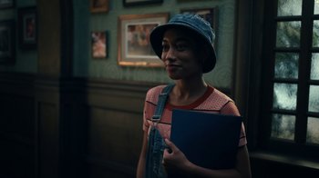 Movie still from “The Midnight Club” (2022), created by Mike Flanagan – A woman holding a book in her hands; Close Up shot, Over the shoulder angle