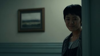 Movie still from “The Midnight Club” (2022), created by Mike Flanagan – A young man standing in front of a painting in a room; Close Up shot, Over the shoulder angle