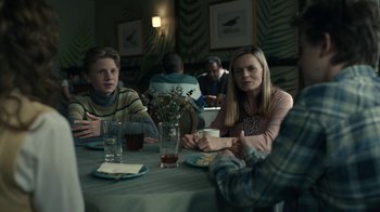 Movie still from “The Midnight Club” (2022), created by Mike Flanagan – A group of people sitting around a table; Medium shot, Over the shoulder angle