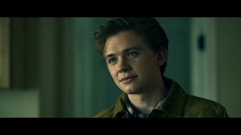 Movie still from “The Midnight Club” (2022), created by Mike Flanagan – A young man is looking into the distance; Close Up shot, Over the shoulder angle