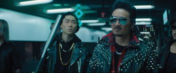 Movie still from “Bullet Train” (2022), directed by David Leitch – A man in a leather jacket standing next to another man in a leather jacket; Medium shot, Low angle