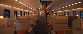 Movie still from “Bullet Train” (2022), directed by David Leitch – A man standing inside of an empty airplane; Extreme Wide shot, High angle