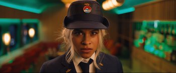 Movie still from “Bullet Train” (2022), directed by David Leitch – A woman in a uniform with a hat on; Close Up shot, Low angle