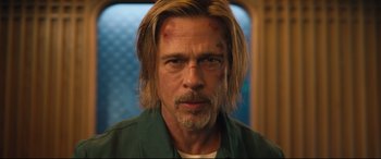 Movie still from “Bullet Train” (2022), directed by David Leitch – A person with long blonde hair; Close Up shot, Low angle