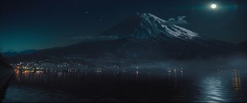 Movie still from “Bullet Train” (2022), directed by David Leitch – A view of a large mountain at night with lights on; Extreme Wide shot, Low angle