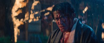 Movie still from “Bullet Train” (2022), directed by David Leitch – A man with blood all over his face and neck; Medium shot, Low angle