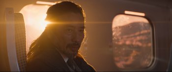 Movie still from “Bullet Train” (2022), directed by David Leitch – A person wearing a suit and tie; Close Up shot, Low angle