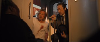 Movie still from “Bullet Train” (2022), directed by David Leitch – Two men are standing next to each other; Medium shot, Over the shoulder angle