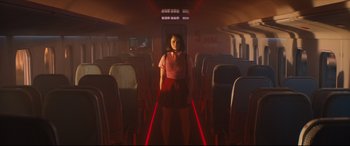 Movie still from “Bullet Train” (2022), directed by David Leitch – A woman standing on a train with red lights; Wide shot, Low angle
